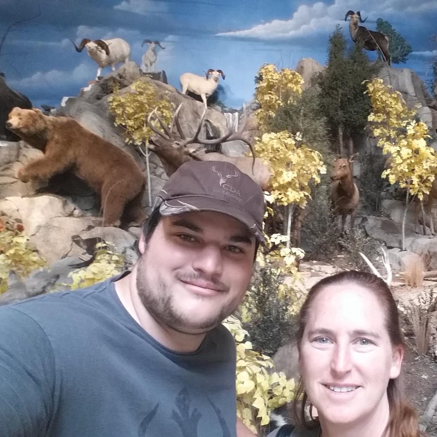 The LanternGlowCraft family posing in front of a wildlife display in a store (the animals are display mounts, not live)